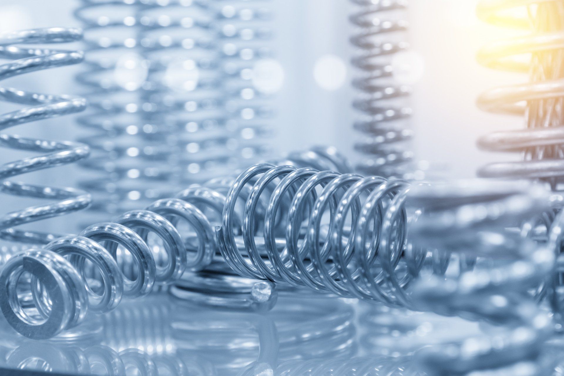 A close up of a bunch of metal springs on a table.