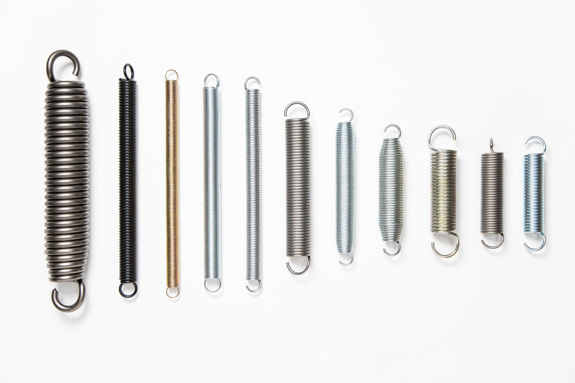 There are many different types of springs on a white background.