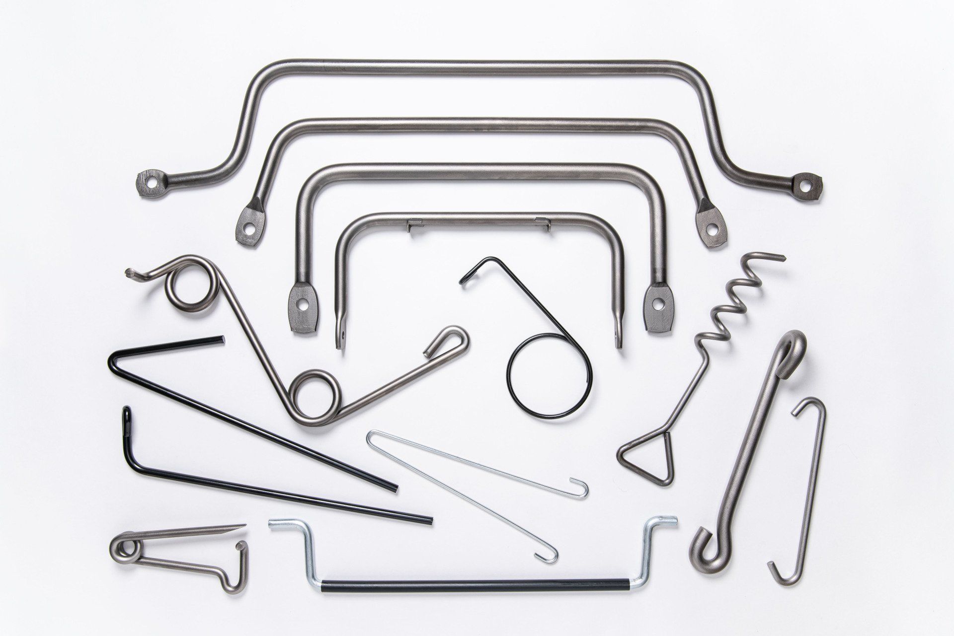 A bunch of metal objects are sitting on a white surface.