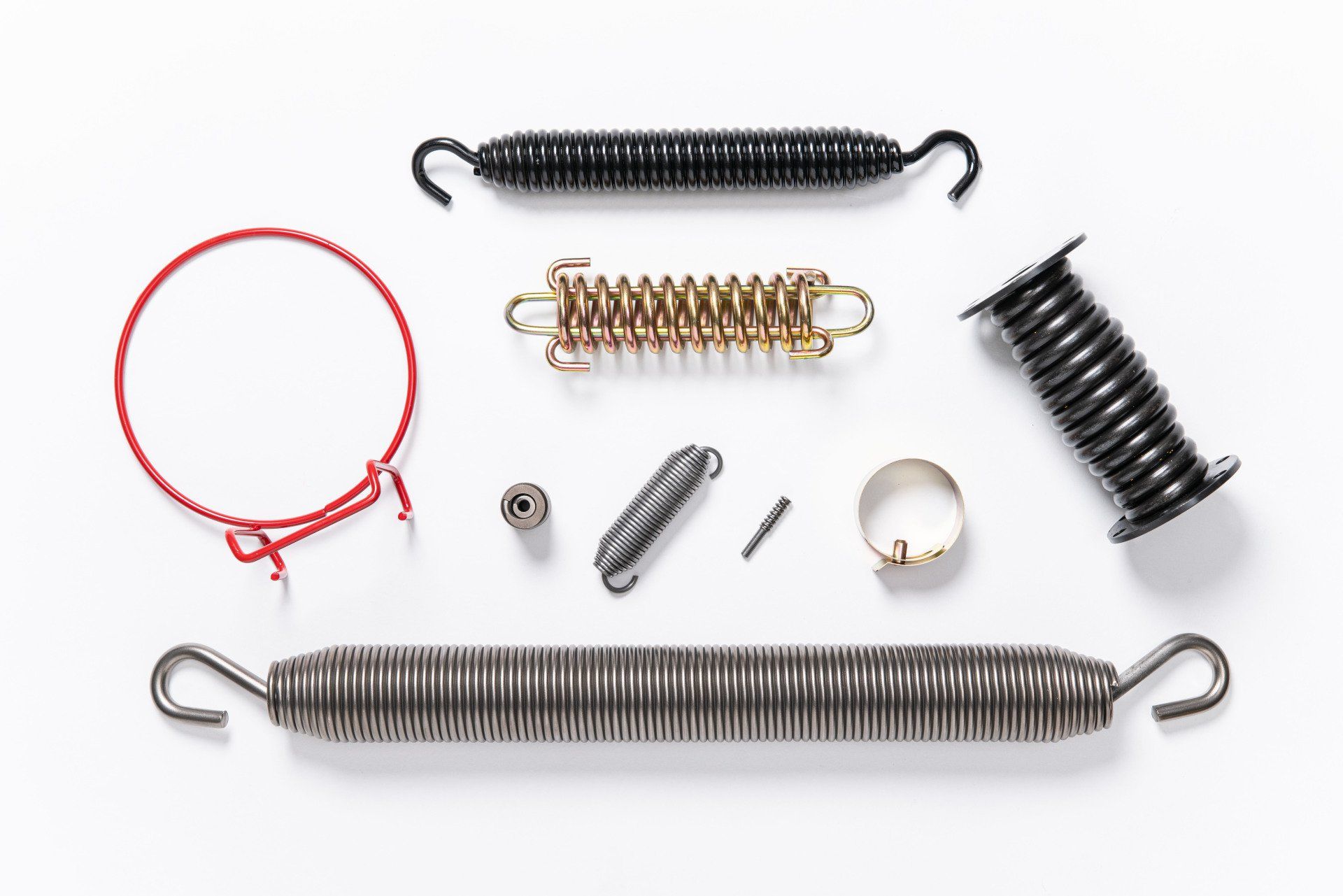 There are many different types of springs on a white surface.