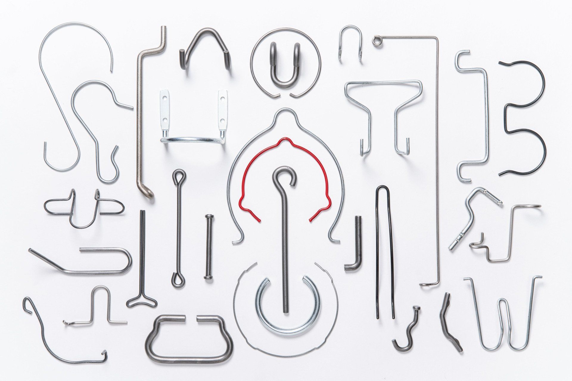 There are many different types of wire hooks on a white background.