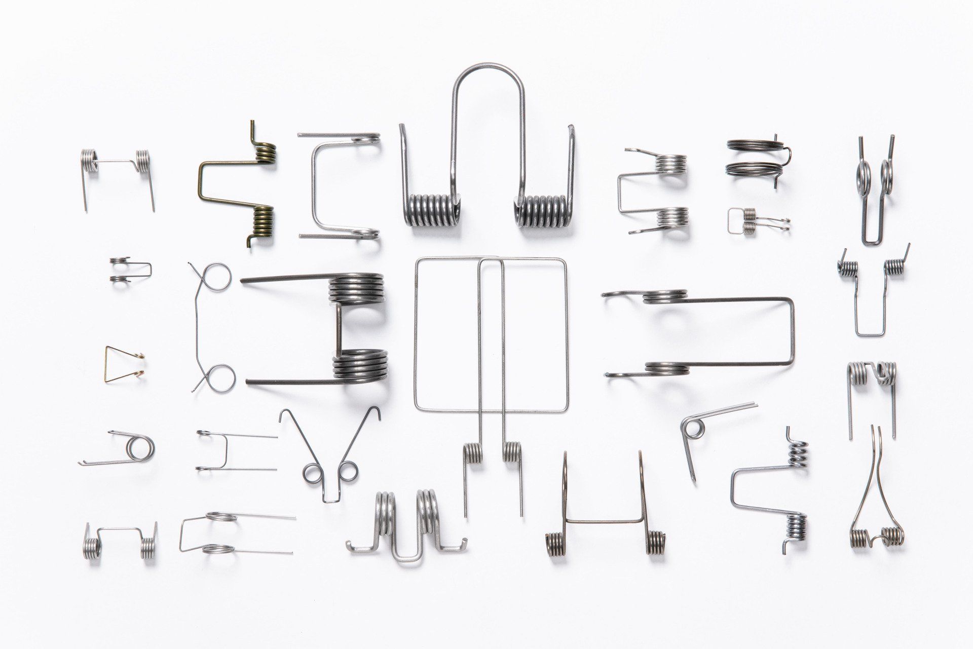 There are many different types of springs on a white background.