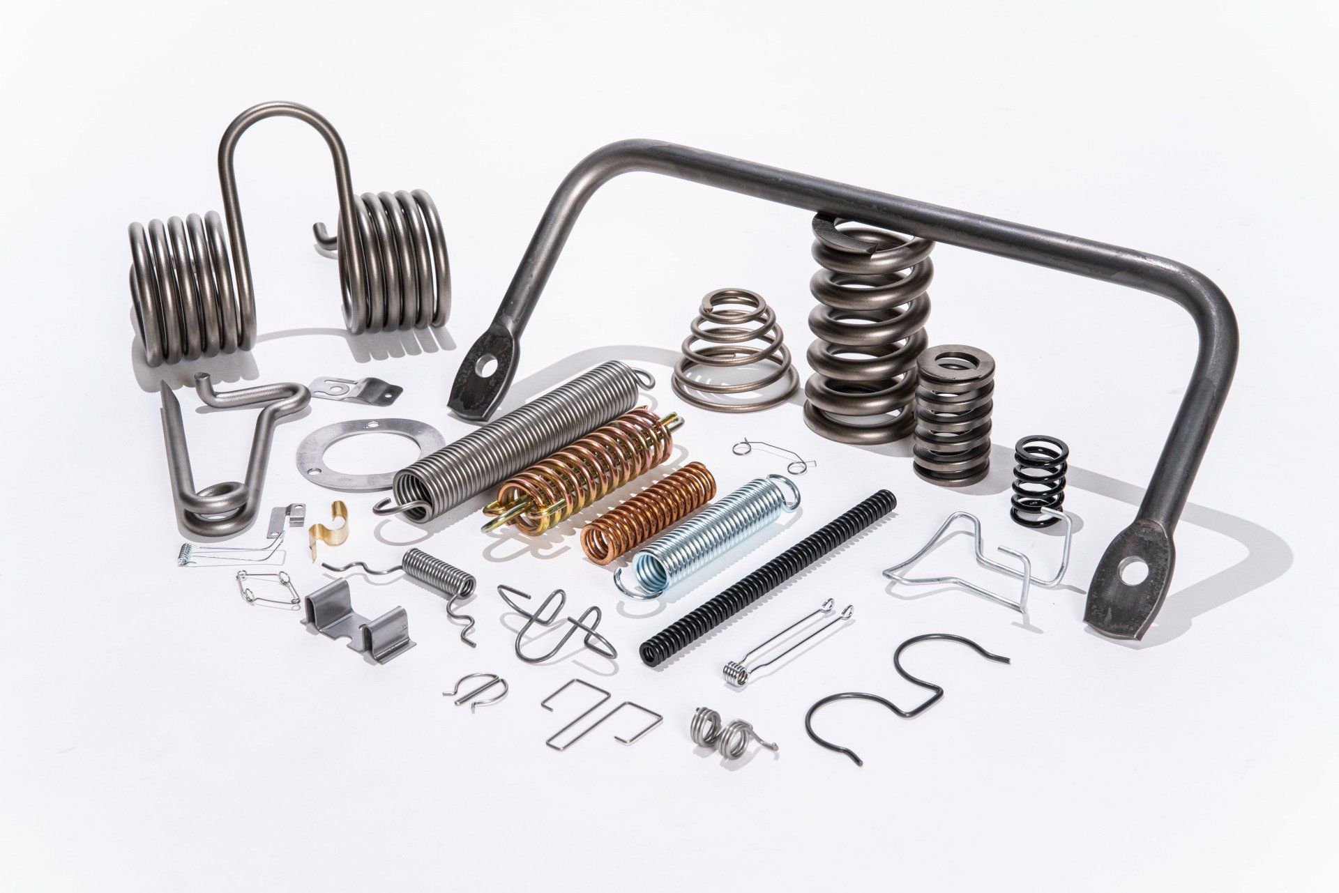 There are many different types of springs and screws on the table.