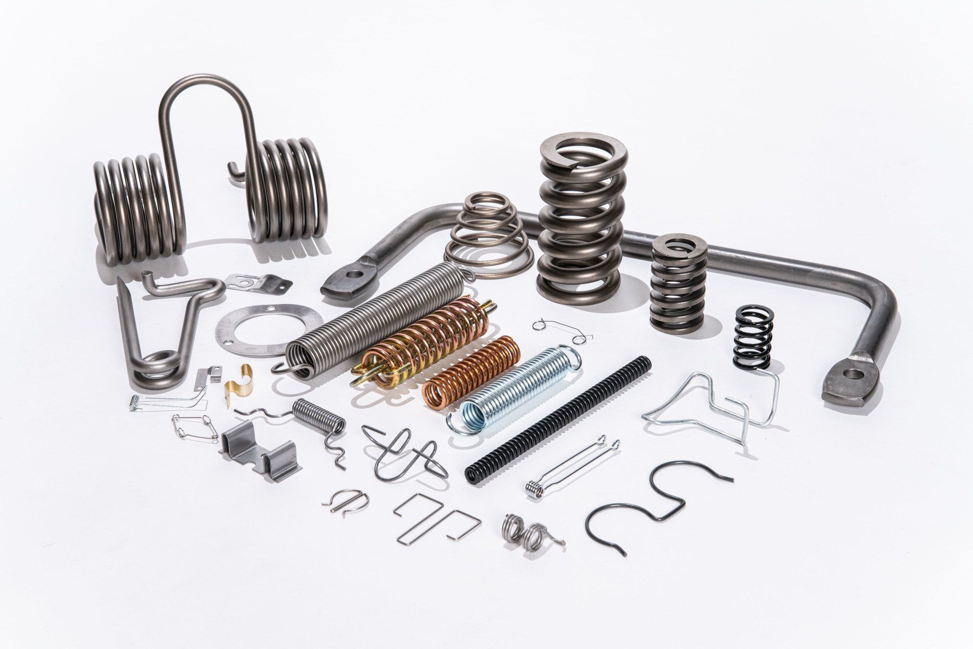 There are many different types of springs and screws on the table.
