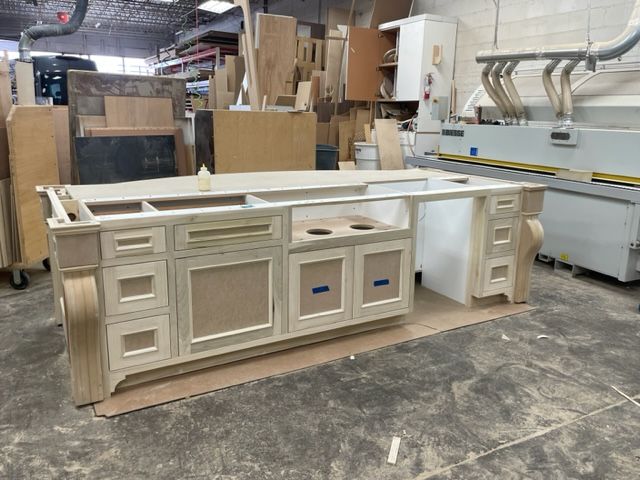 A kitchen island is being built in a factory.