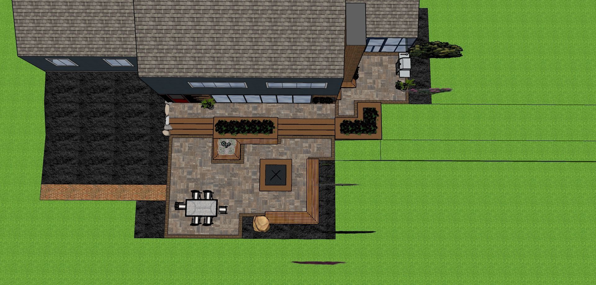 Overhead view of a modern home with a patio and outdoor seating area on green grass.