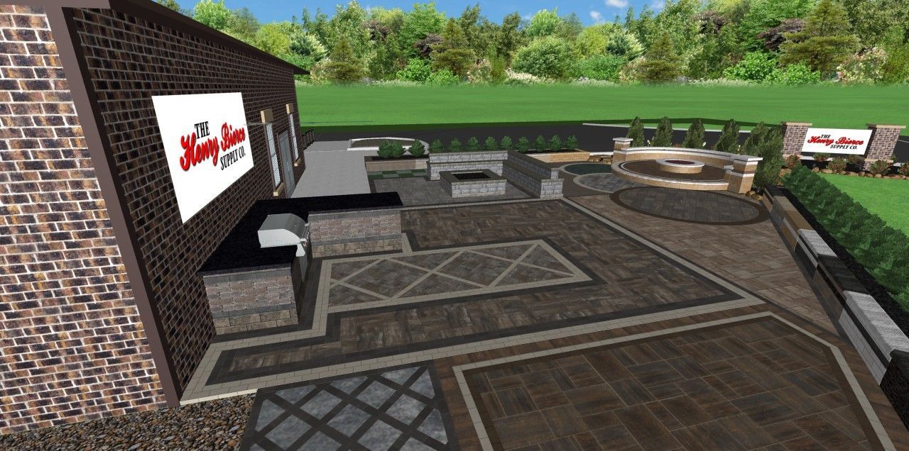 Exterior view of a brick building with a sign, patio, and landscape featuring trees and grass.