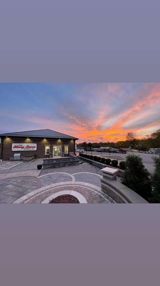 Building exterior at dusk with orange and blue sky.