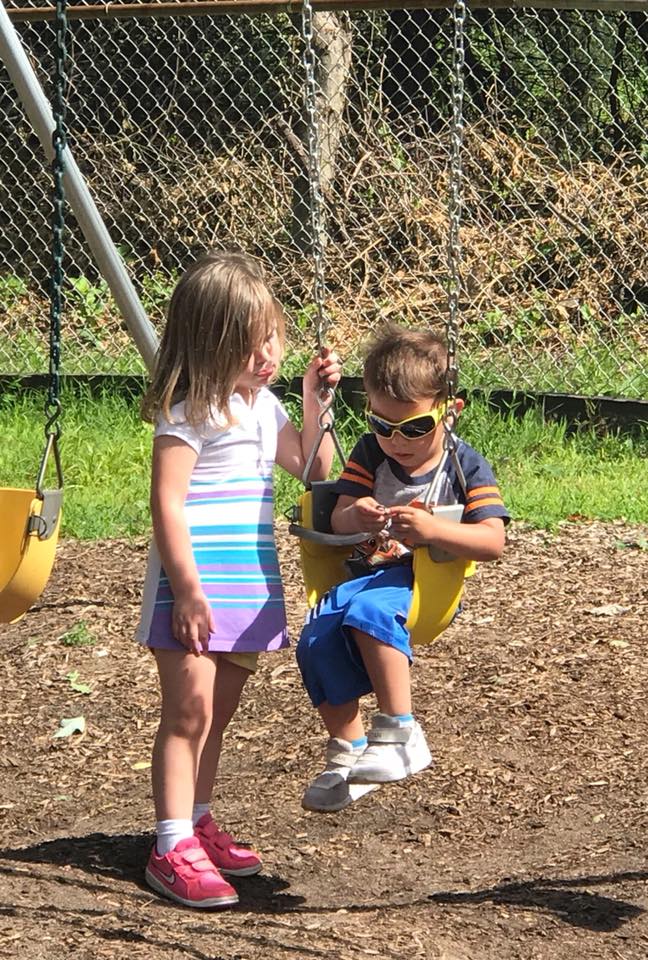 Little Girl Watching Her Brother in a Swing — Wappinger Falls, NY — Raising the Standard for Child Care Services