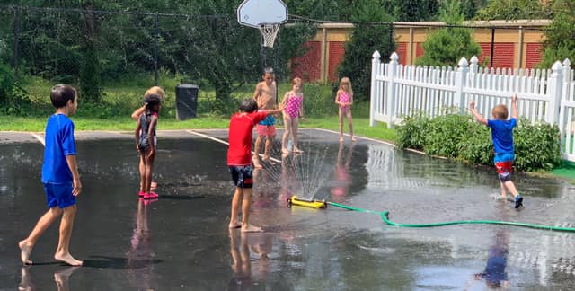 Kids Enjoying Playing with the Sprinkler — Wappinger Falls, NY — Raising the Standard for Child Care Services