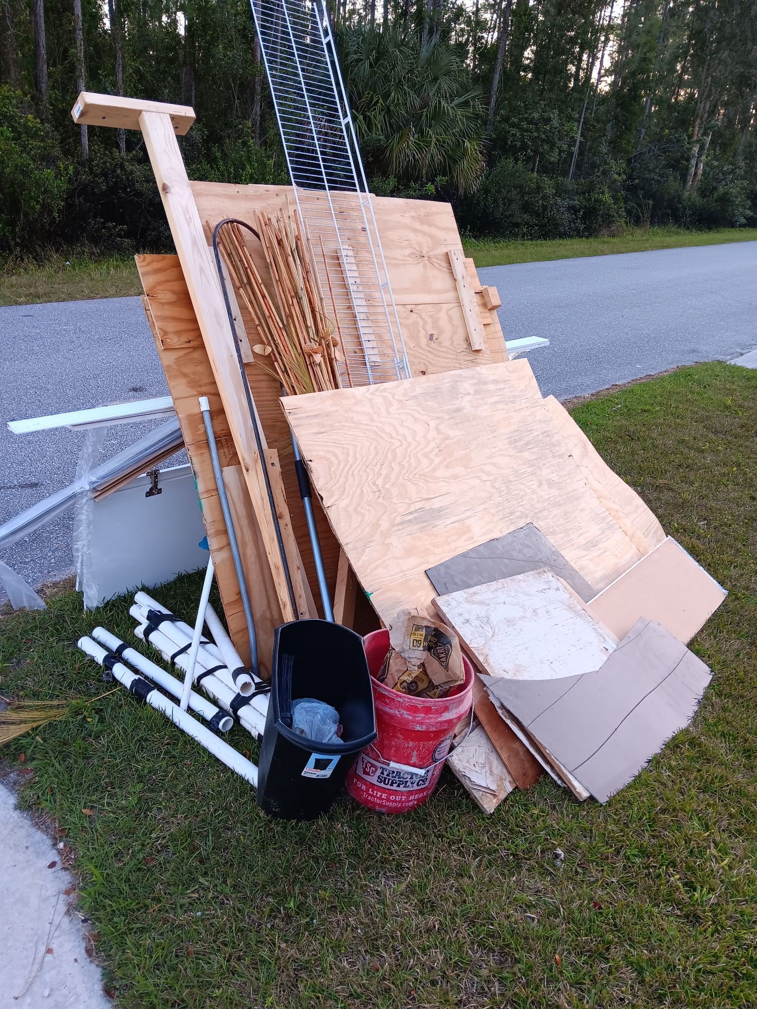 A pile of trash is sitting on the side of the road.