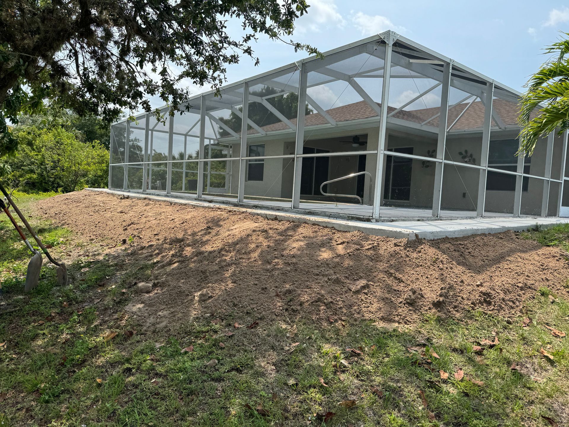 A screened in porch is being built in front of a house.