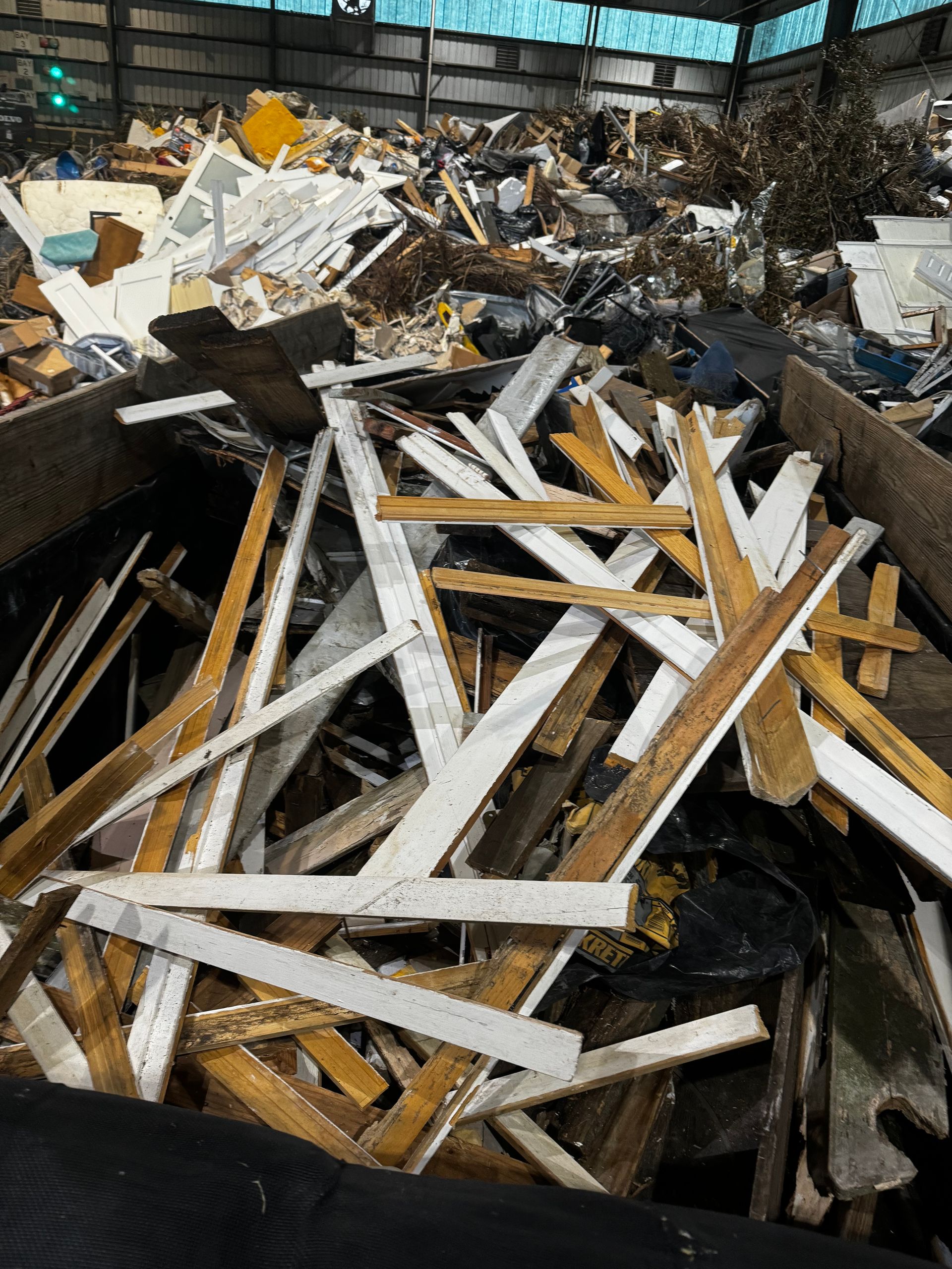 A pile of wood and metal scraps in a bin.