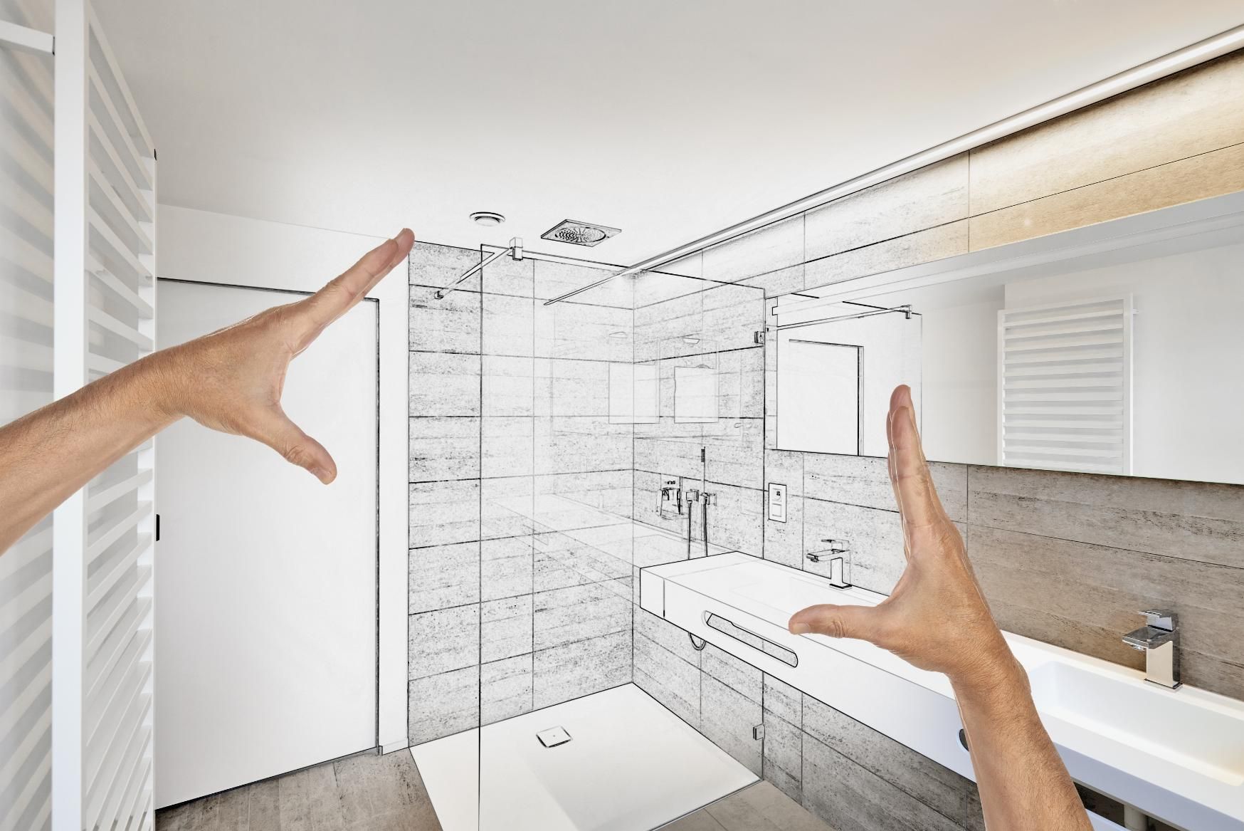 Hands framing a bathroom, with a partially drawn shower design.