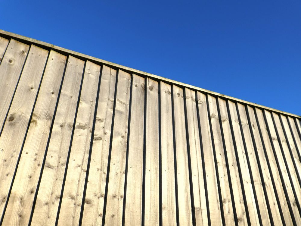 A Wooden Fence with a Blue Sky in the Background — Sly Bros in Maclean, NSW