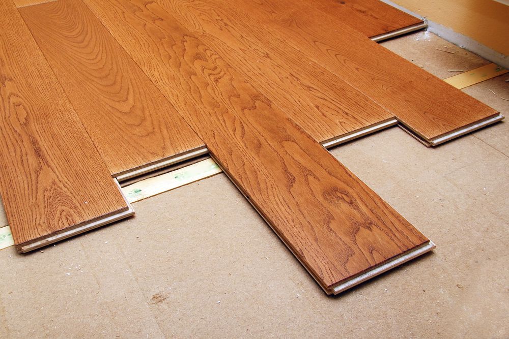 Wooden Plank is being Installed on the Floor — Sly Bros in Woodburn, NSW
