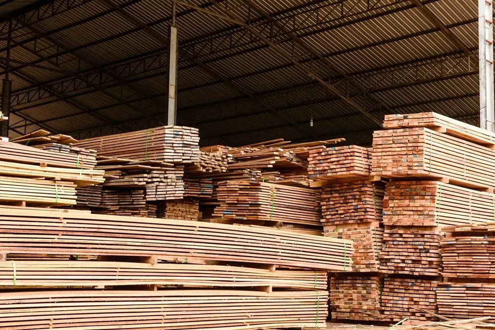 A Large Warehouse Filled With Lots of Wooden Boards — Sly Bros in Woodburn, NSW