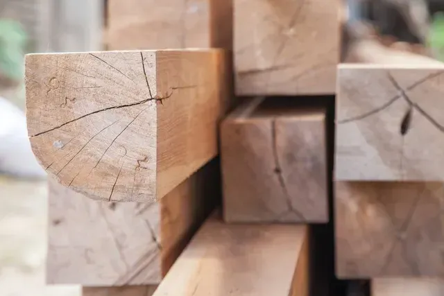 A Detailed View of a Stack of Timber Beams Showing Cracks — Sly Bros in Mullumbimby, NSW