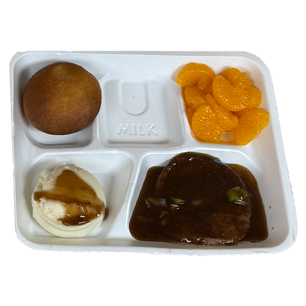 A plastic tray filled with food including a piece of meat