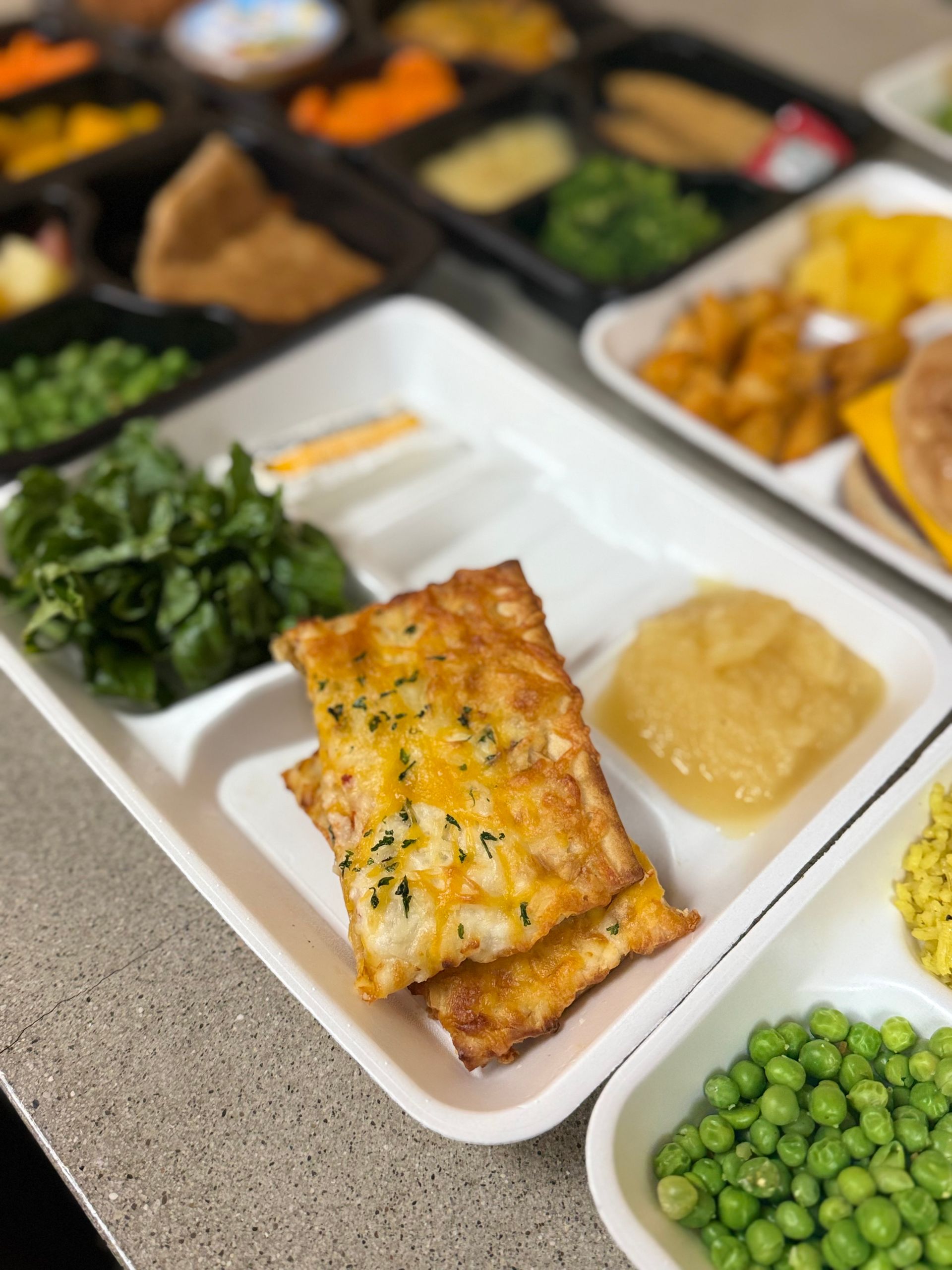 A tray of food with a piece of cheese on it