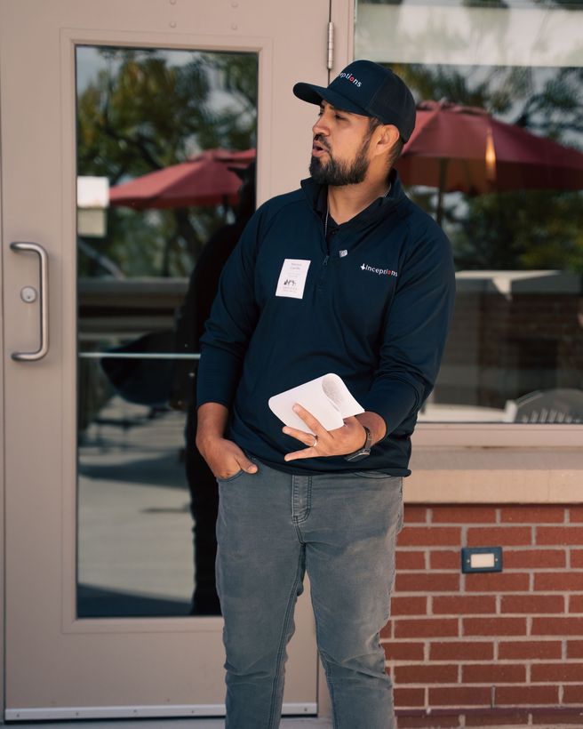 A man standing in front of a door holding a piece of paper