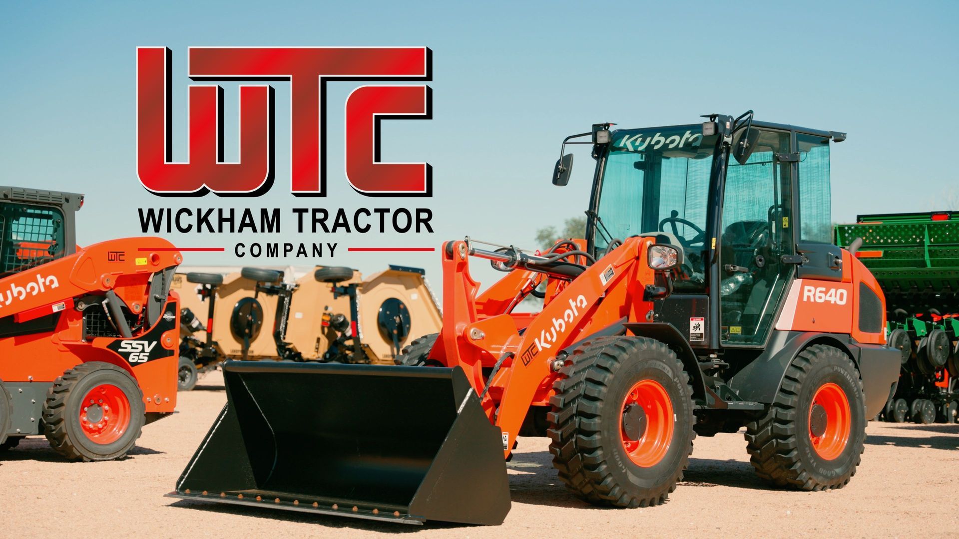 A couple of tractors are parked next to each other on a dirt road.