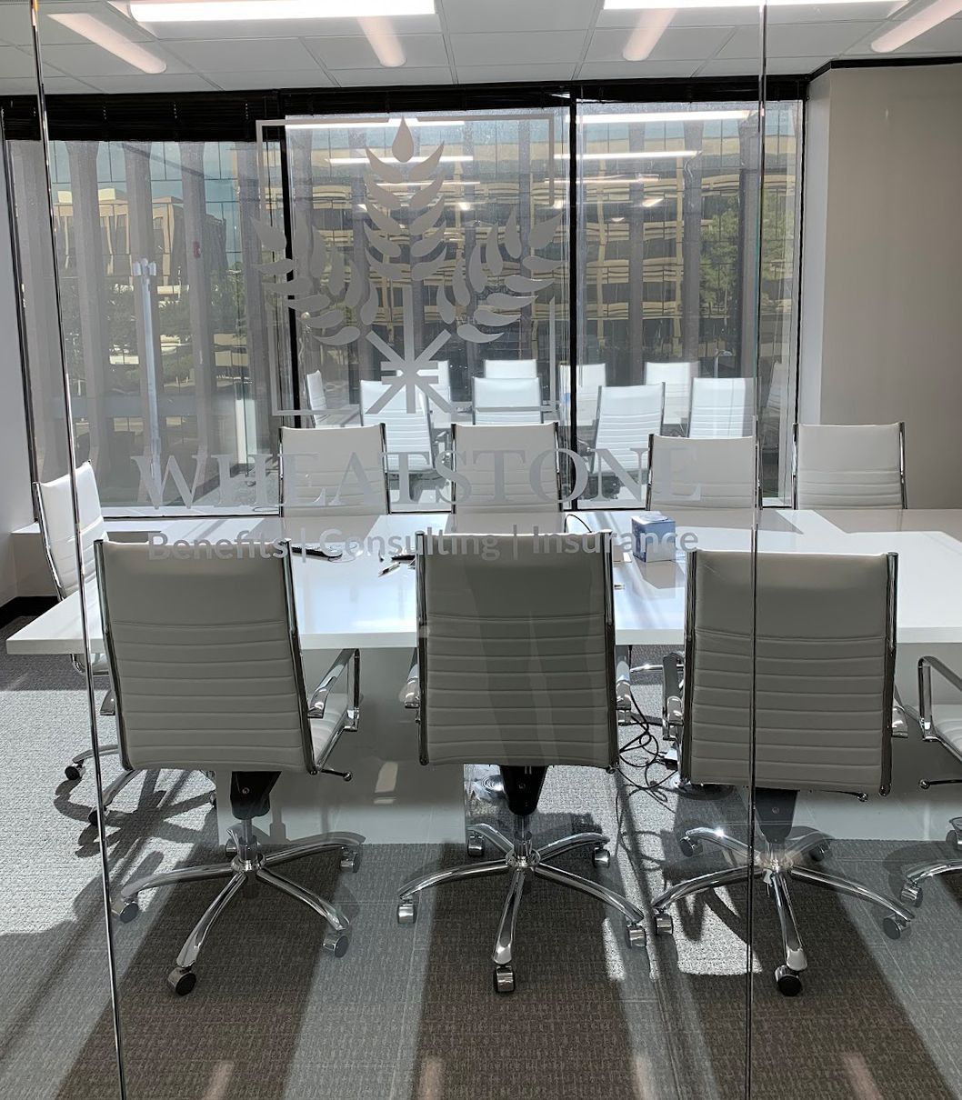 Sign for Wheatstone Benefits, Consulting, Insurance. Logo of wheat. Office interior.