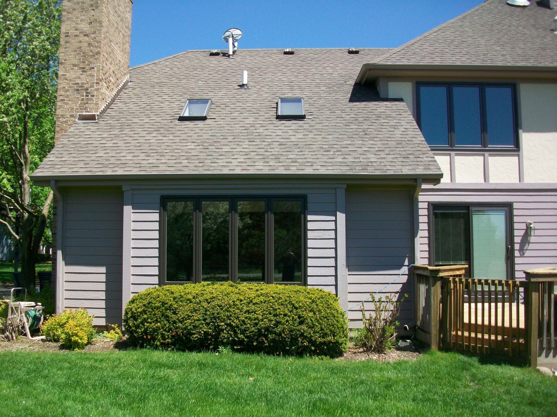 A house with a lot of windows and a deck