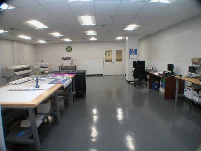 A large room with a lot of tables and desks