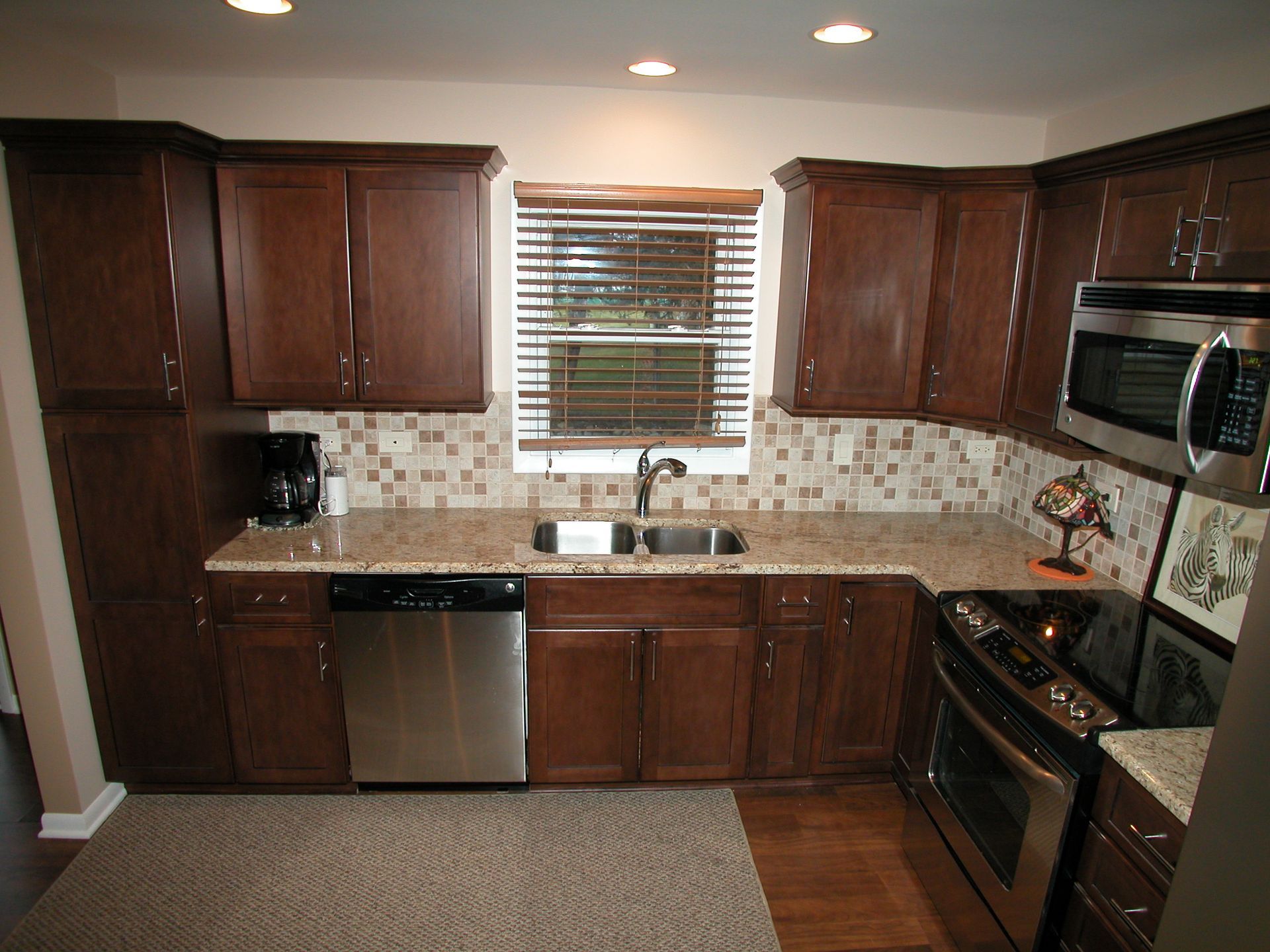 A kitchen with stainless steel appliances and wooden cabinets