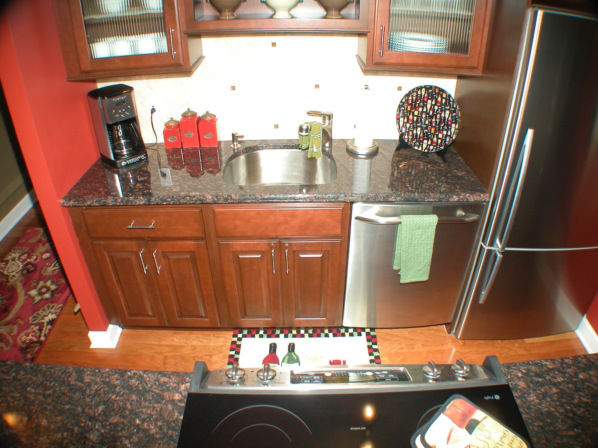 A kitchen with stainless steel appliances and wooden cabinets