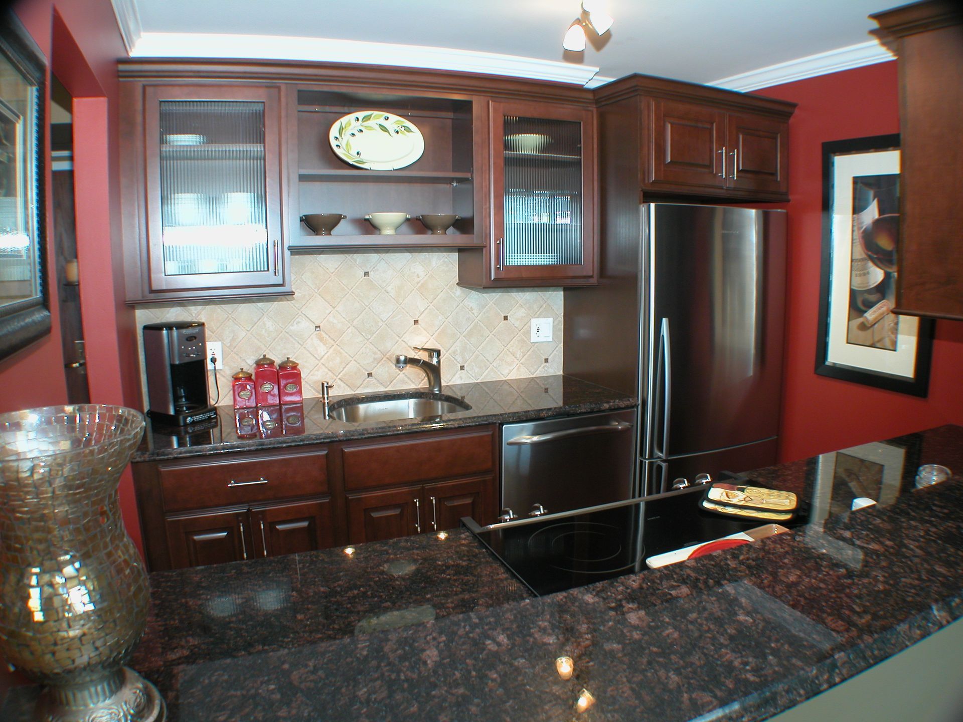 A kitchen with stainless steel appliances and granite counter tops