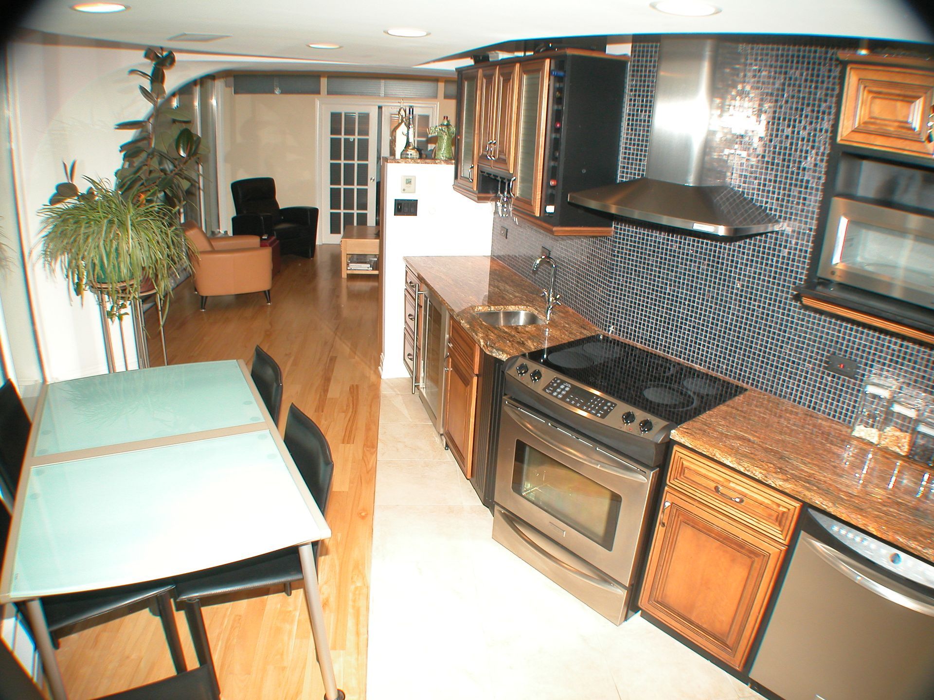 A kitchen with stainless steel appliances and granite counter tops