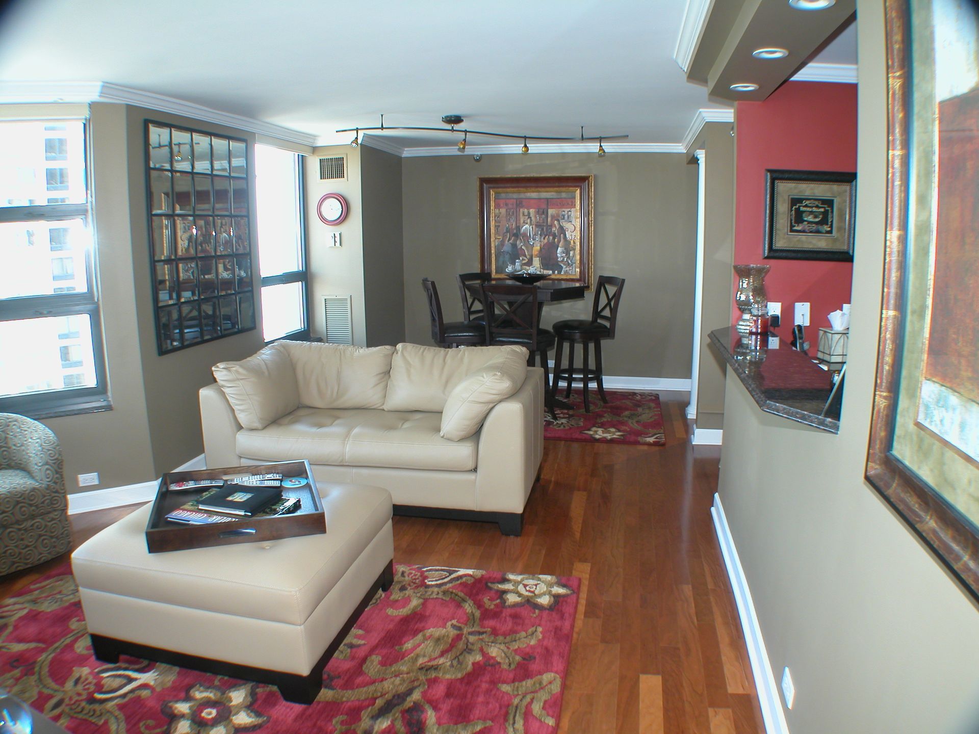 A living room with a couch and ottoman in it