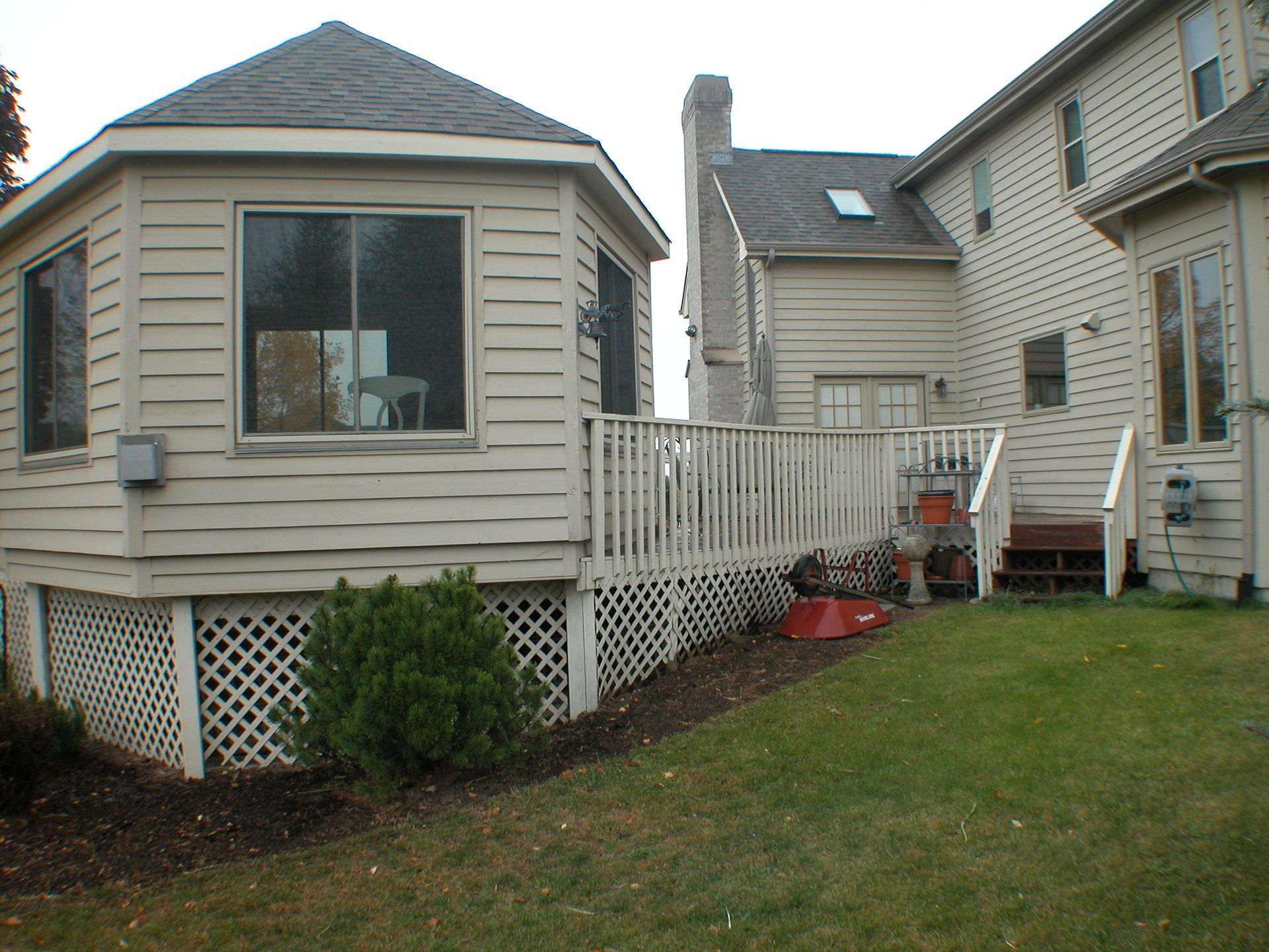 The backyard of a house with a deck and stairs