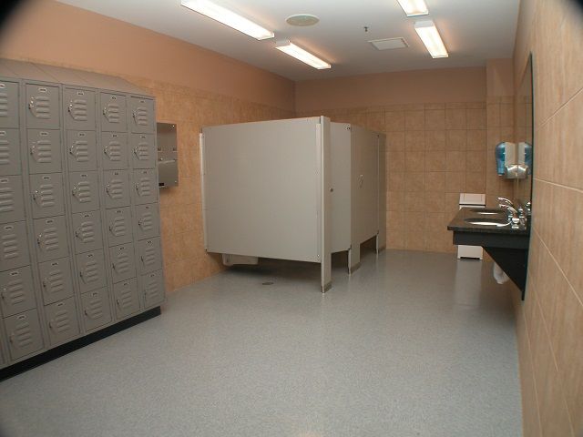A bathroom with lockers and a sink in it
