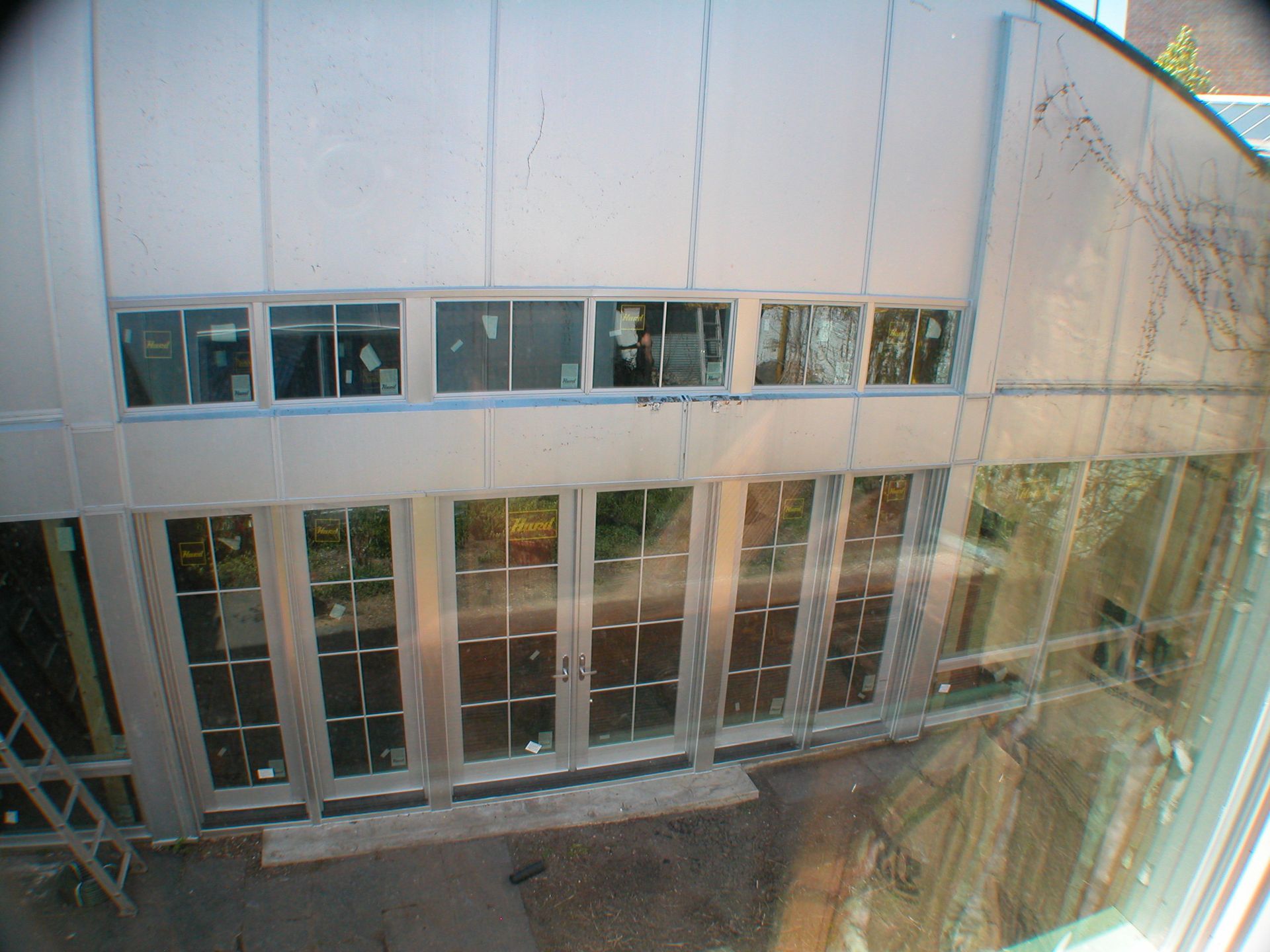 A building with a lot of windows and doors is being built.