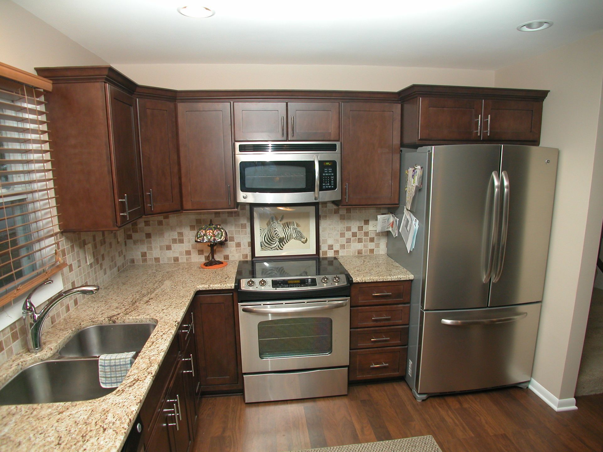 A kitchen with stainless steel appliances and granite counter tops