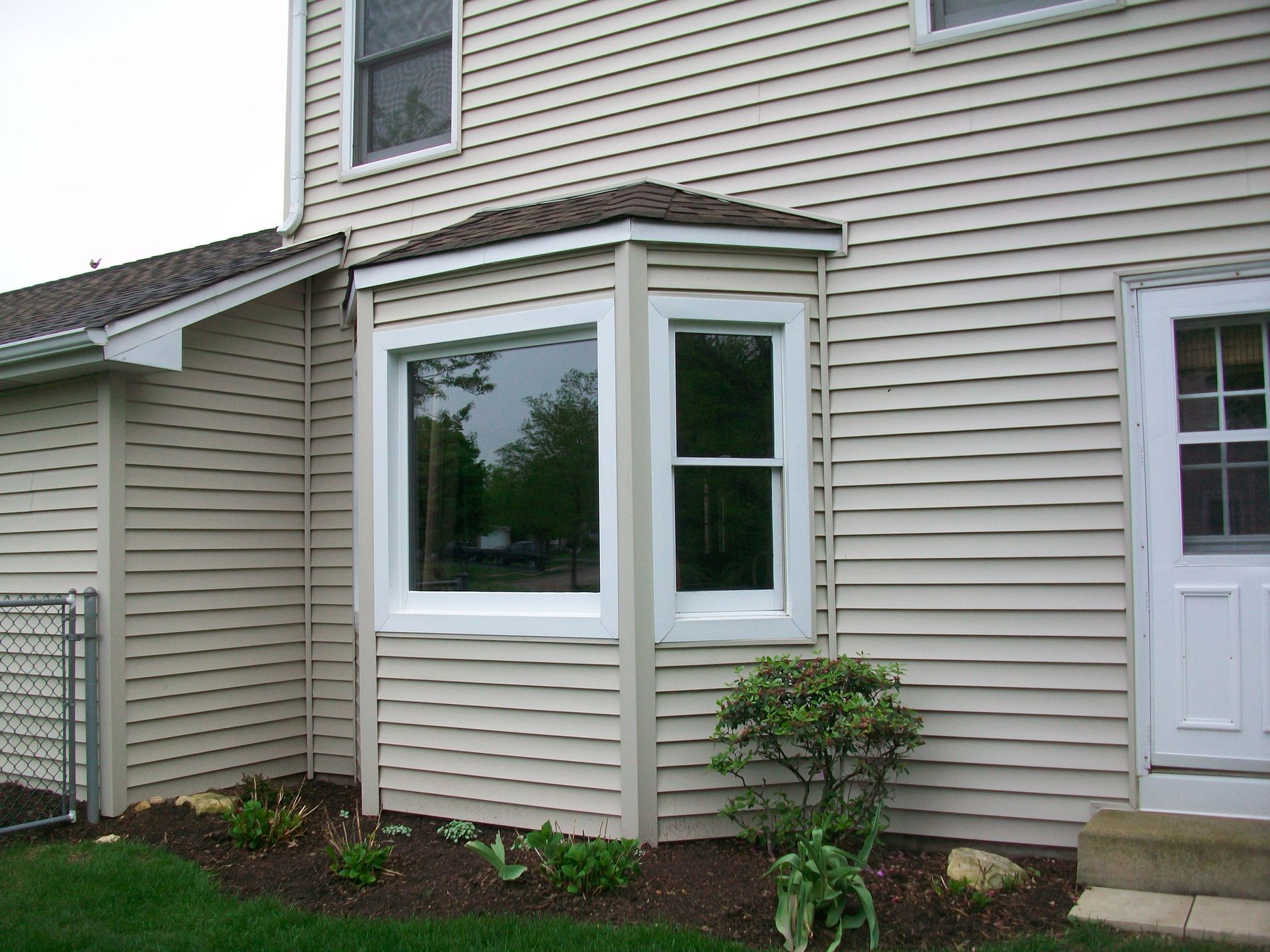 A house with a bay window and a white door