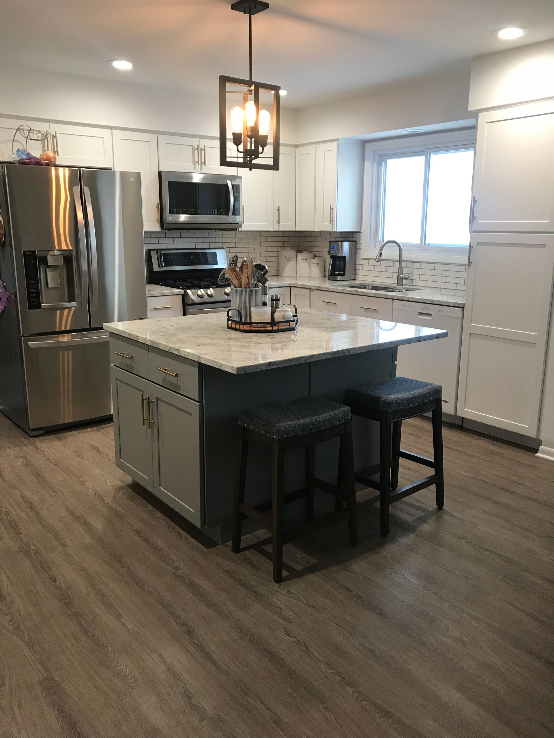 A kitchen with a large island and stools