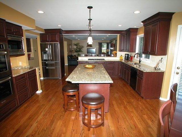 A kitchen with a large island and stools