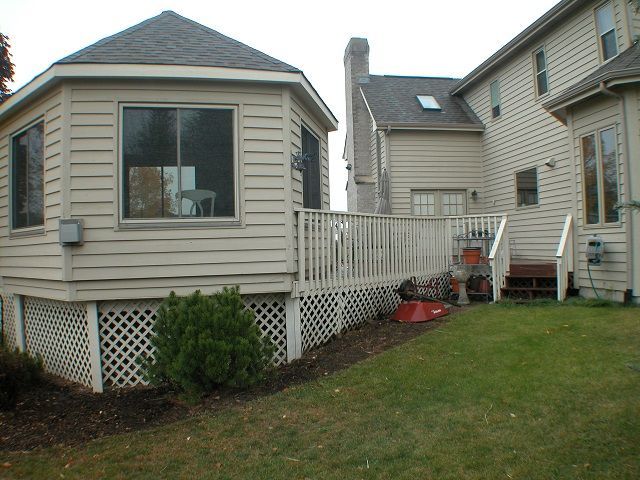 A house with a deck and a gazebo in the backyard