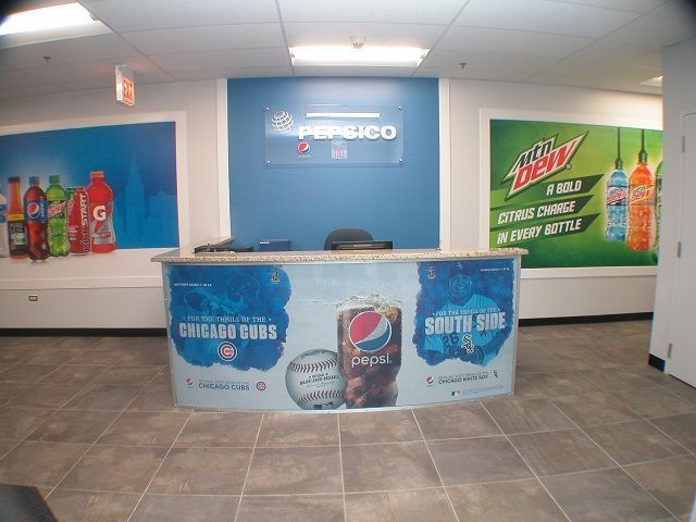 A pepsi and mountain dew sign hangs above a counter