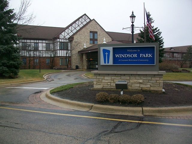 A large building with a windsor park sign in front of it