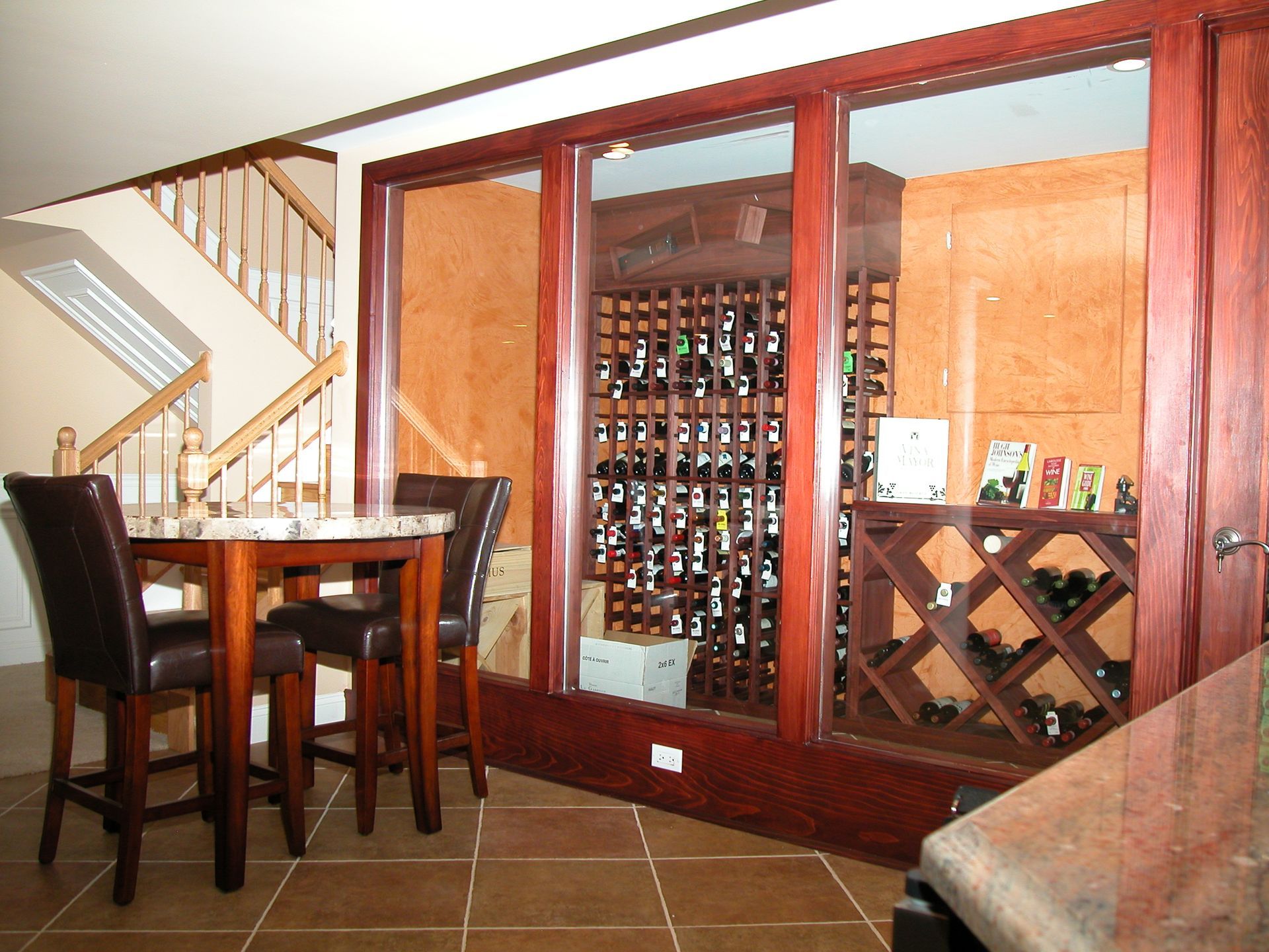 A wine cellar with a table and chairs in front of it