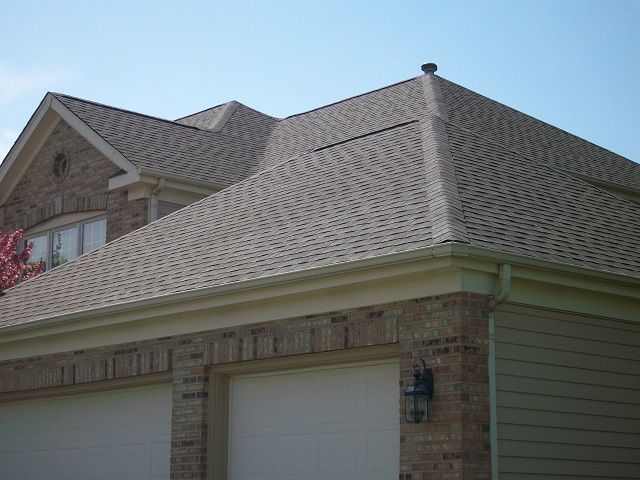 A house with a roof that has shingles on it