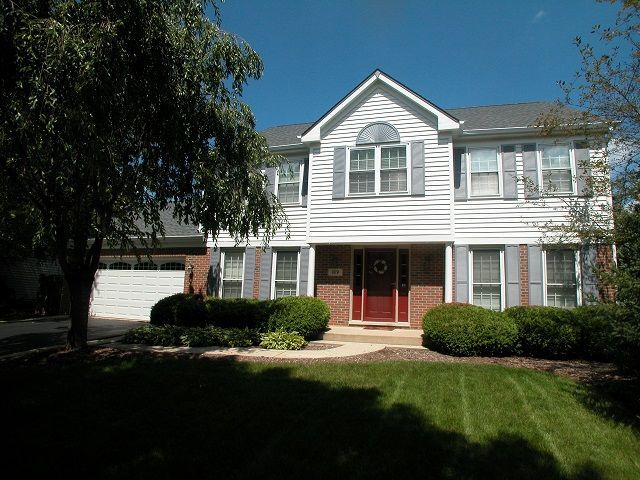 A large white house with a red door