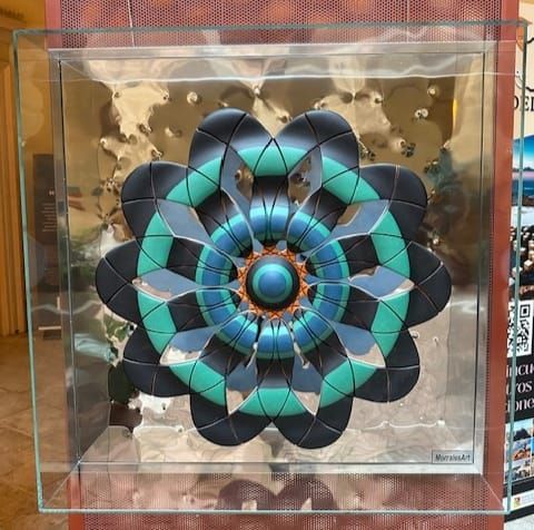 Scultura floreale 3D in teca di vetro, design geometrico nei colori verde acqua, nero e argento.