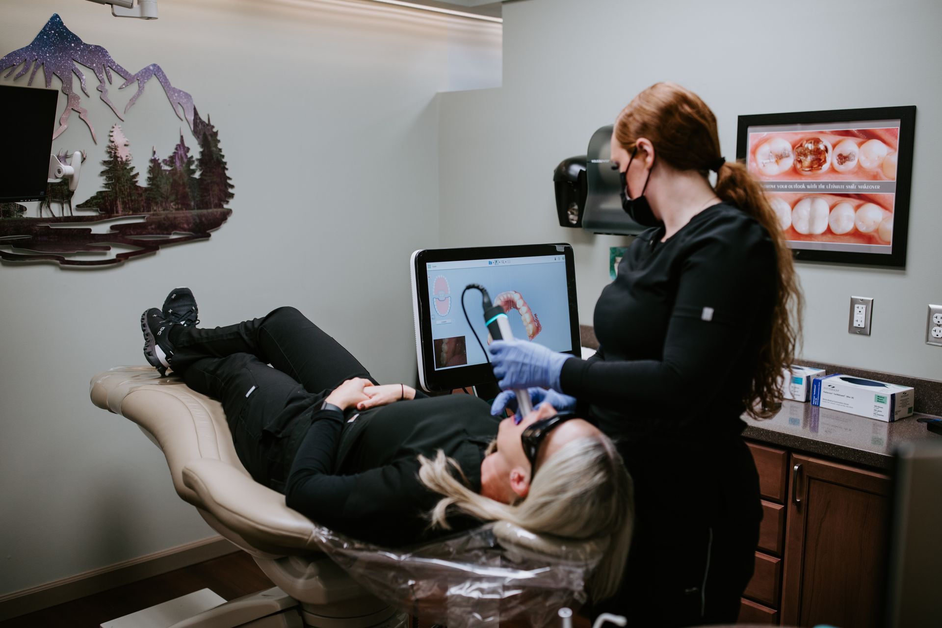 A dental office with a computer and a dental chair.