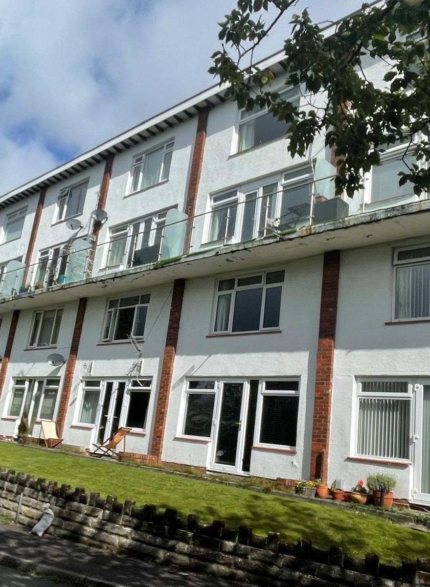 A large white building with a lot of windows and balconies